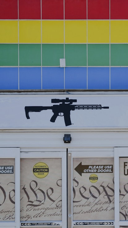 The silhouette of an AR-15 style rifle is displayed on signage for the Firearms Unknown Guns & Ammo ...