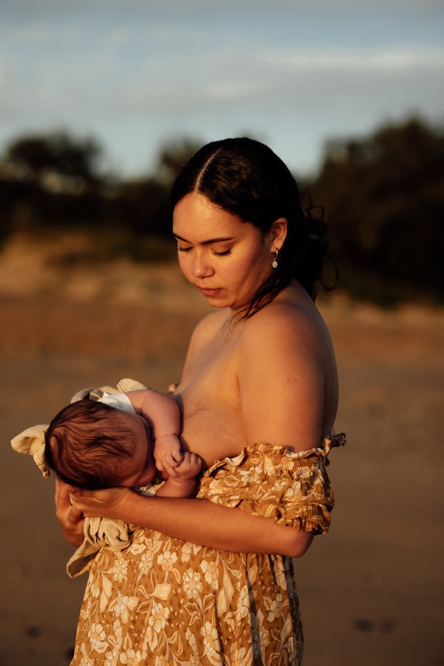 mom breastfeeding at sunset