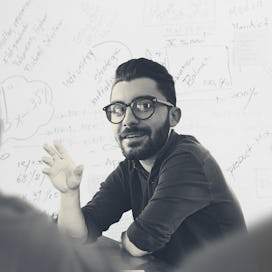 A man talking to his co-workers at work