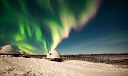 The aurora borealis over the borealis basecamp igloo