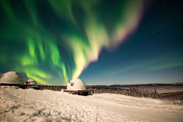 The aurora borealis over the borealis basecamp igloo