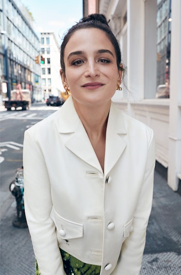 Close-up of Jenny Slate on streets of New York wearing a white Dior jacket