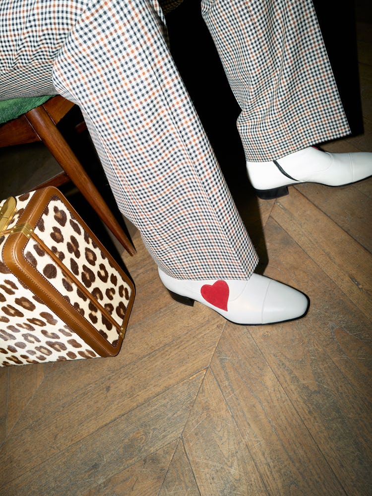 A leopard-print briefcase and white boot with a heart from the Gucci HA HA HA collection