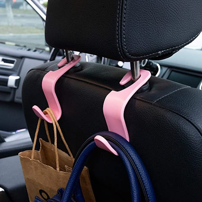 Car head rest hooks allow you to hang purses, tablets, and more so they don't topple over while you'...