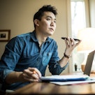 Asian man talking on phone in his office