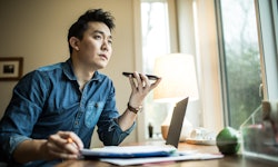 Asian man talking on phone in his office