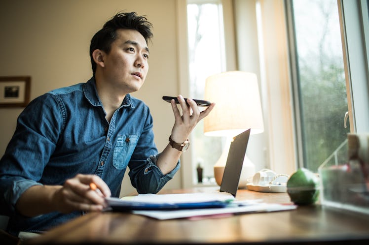 Asian man talking on phone in his office