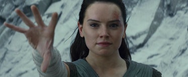 Rey smiles while holding out her hand at the end of 'Star Wars: Episode VIII -- The Last Jedi'