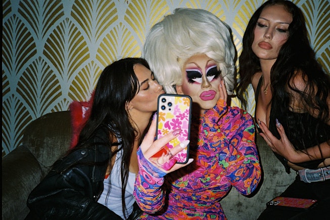 Trixie Mattel taking a selfie with two fans and supporting Pride month