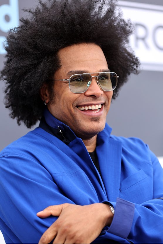 Maxwell smiling while wearing his naturally curly hair look