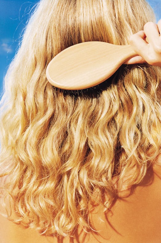 dry hair curls woman brushing her hair