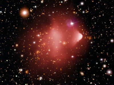 Bullet Cluster, which looks like two pink clouds with one bullet-like in front