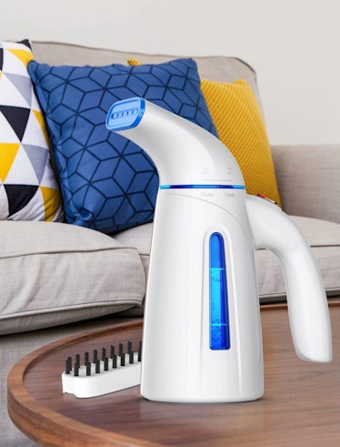 OGHom handheld steamer with steam coming out of it