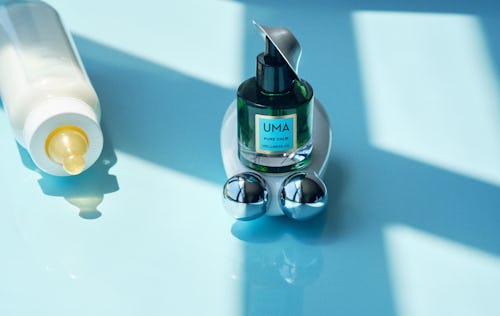 A beauty device for pregnant women, along side Uma pure calm wellness oil and a baby bottle