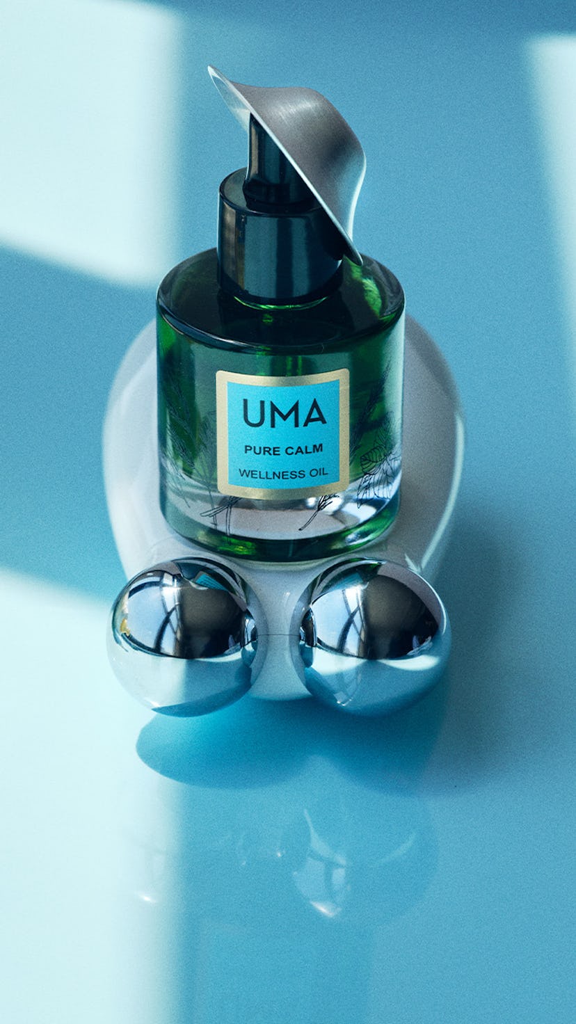 A beauty device for pregnant women, along side Uma pure calm wellness oil and a baby bottle