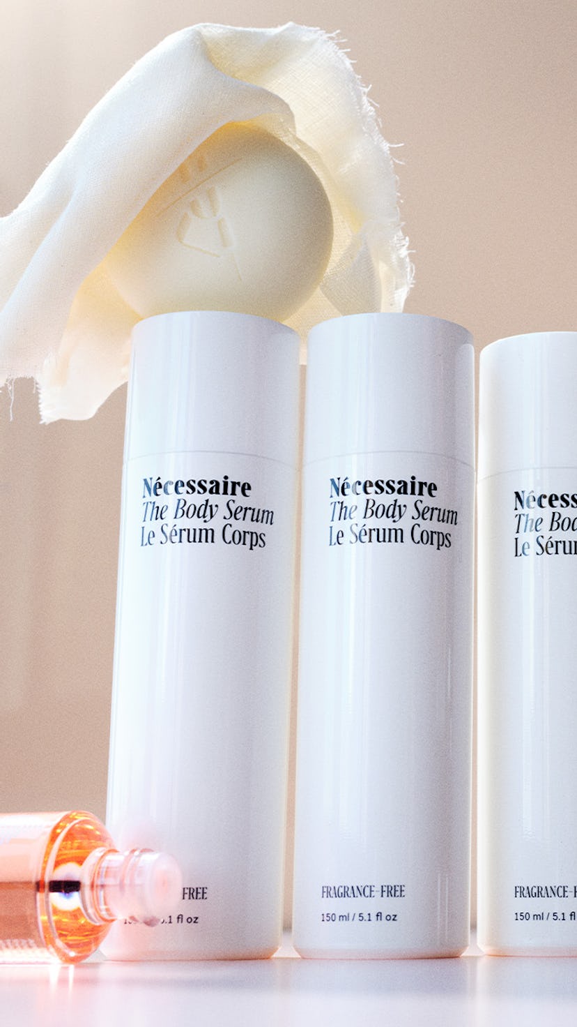 Bottles of Romper Pregnancy Beauty Awards winner Necessaire body serum, white soap, and a cloth