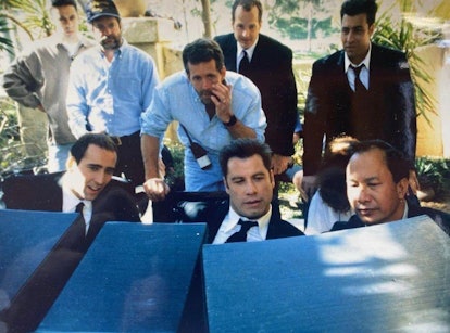 John Travolta, John Woo, Nicolas Cage, and others on the set of Face/Off.