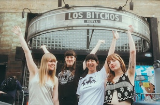 The Los Bitchos band members posing in front of the Music Hall of Williamsburg in New York