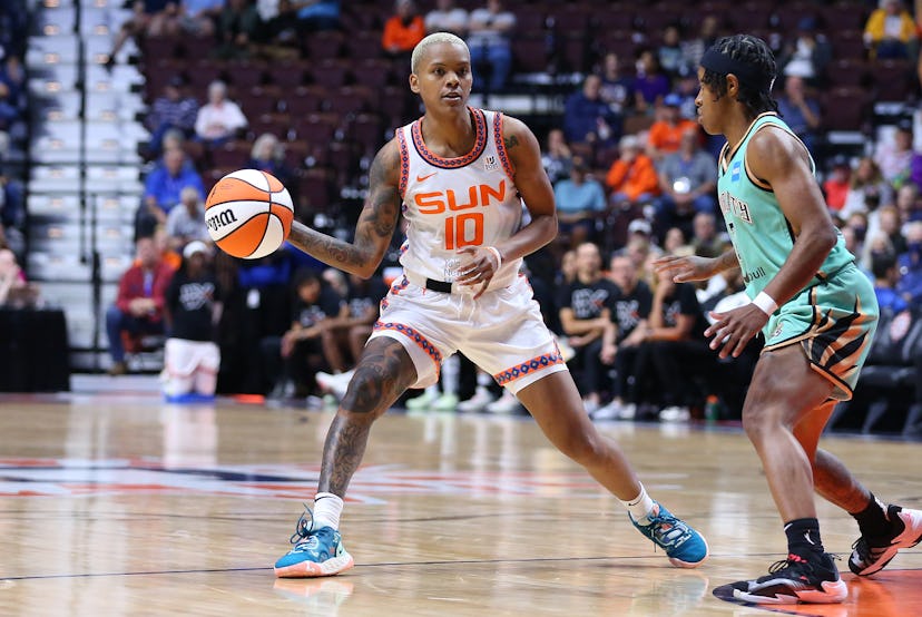 New York Liberty player Crystal Dangerfield guard’s Courtney Williams of the Connecticut Sun, during...