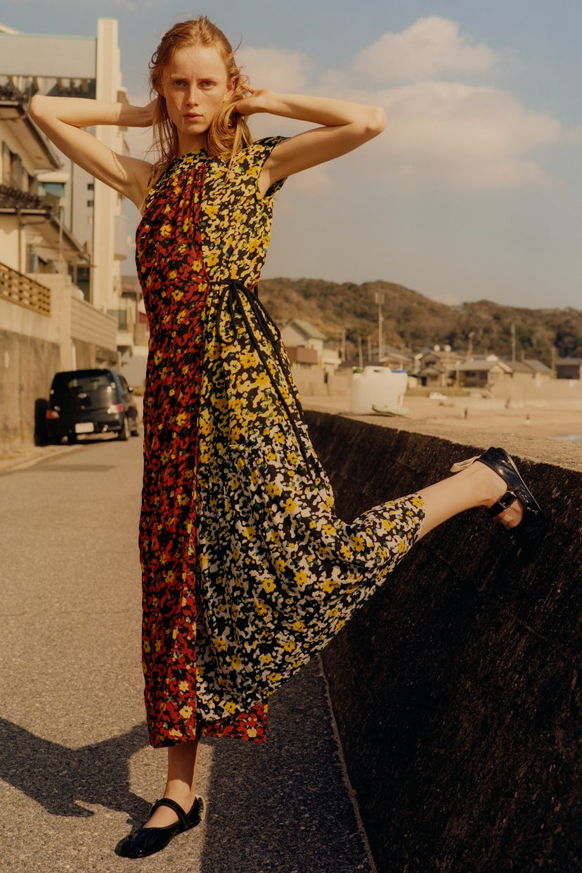 the model Rianne van Rompaey wearing a colorful dress on a coastal road in Japan