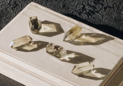 Citrine crystals, great for empaths, on a white wooden box