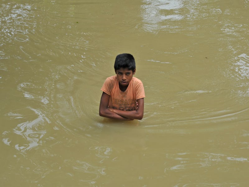 Boy standing in floodwaters in Bangladesh