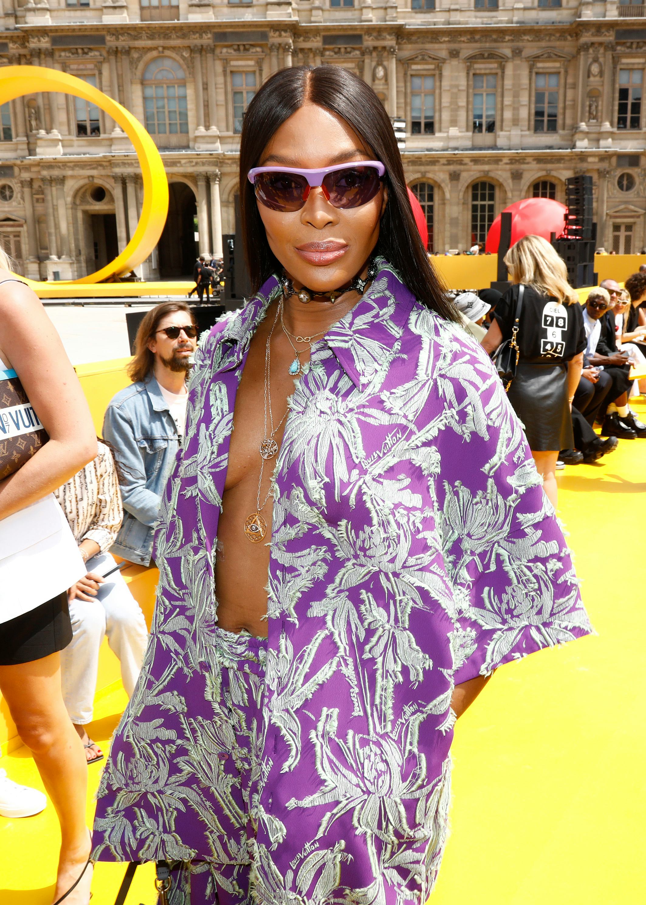 Naomi Campbell wearing an open purple shirt