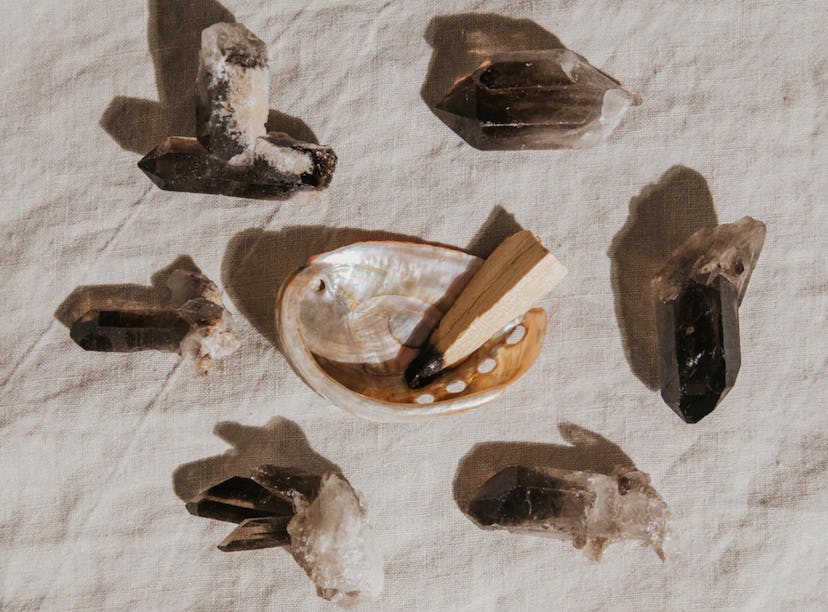 Six smoky quartz crystals around an abalone shell with palo santo. Cleansing crystals helps restore ...