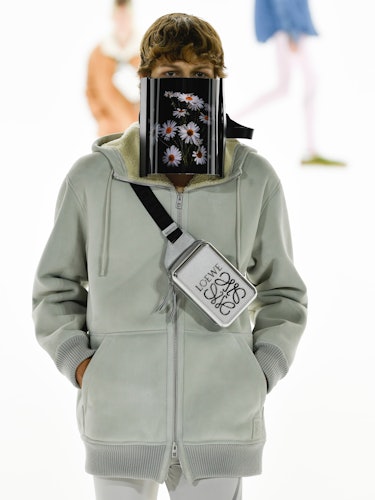 A model wearing a screen on their face on the Loewe spring 2023 menswear runway