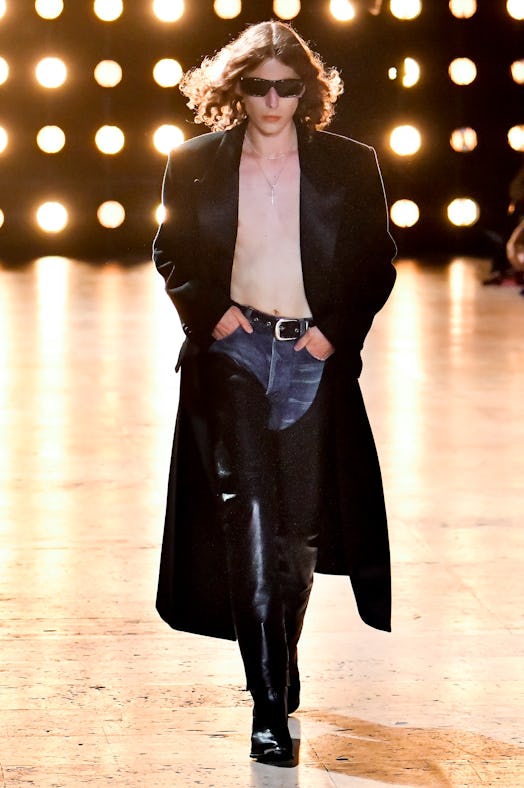 A shirtless model wearing sunglasses on the Celine spring 2023 menswear runway