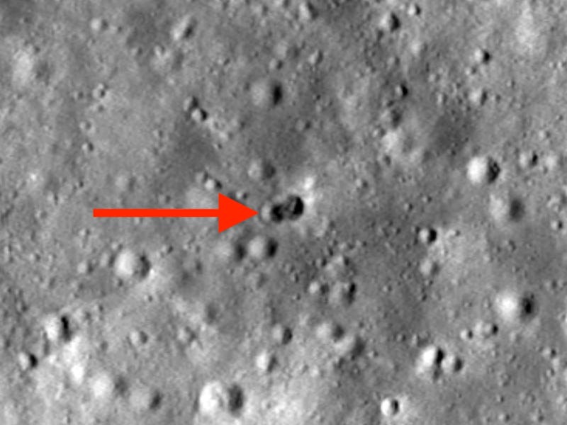 Crater image with a red arrow pointing at the site of a rocket booster crash