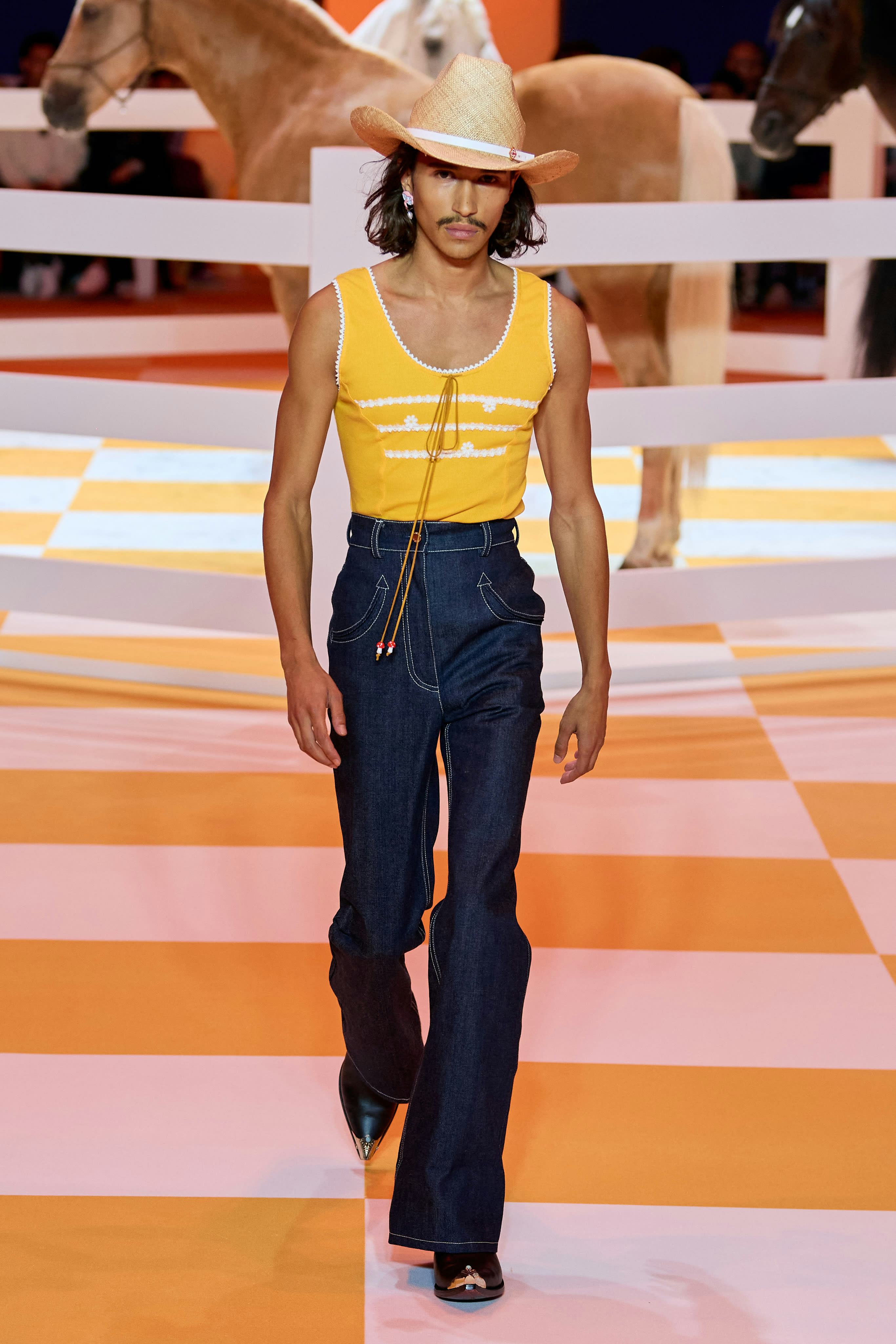 A model wearing a cowboy hat on the Casablanca spring 2023 menswear runway