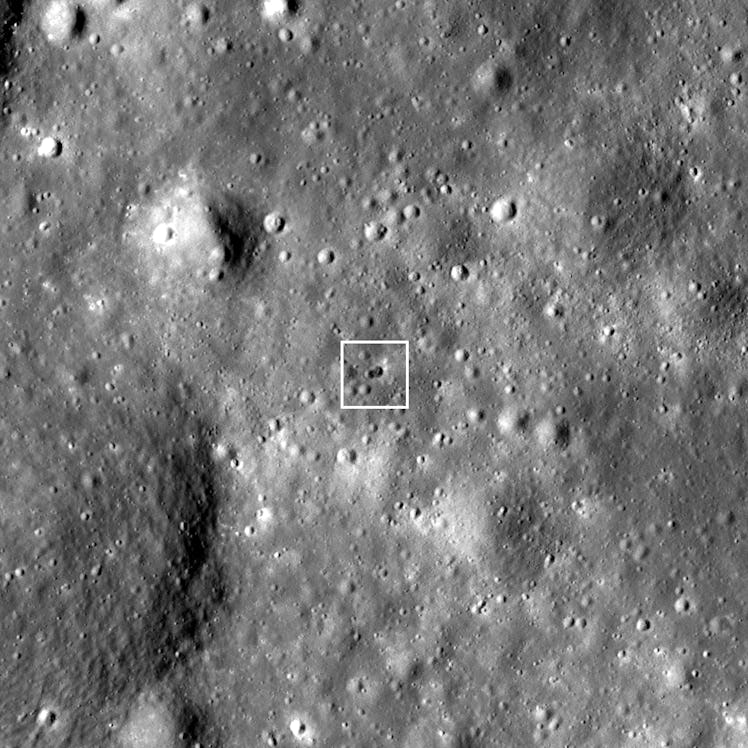 Black and white photo of the lunar surface, with an impact crater marked by a square
