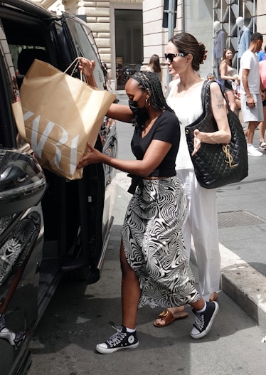Zahara Jolie-Pitt and Angelina Jolie heading into a car after shopping at Zara