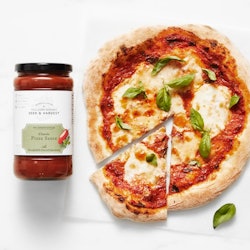 pizza with seed & harvest sauce jar next to it