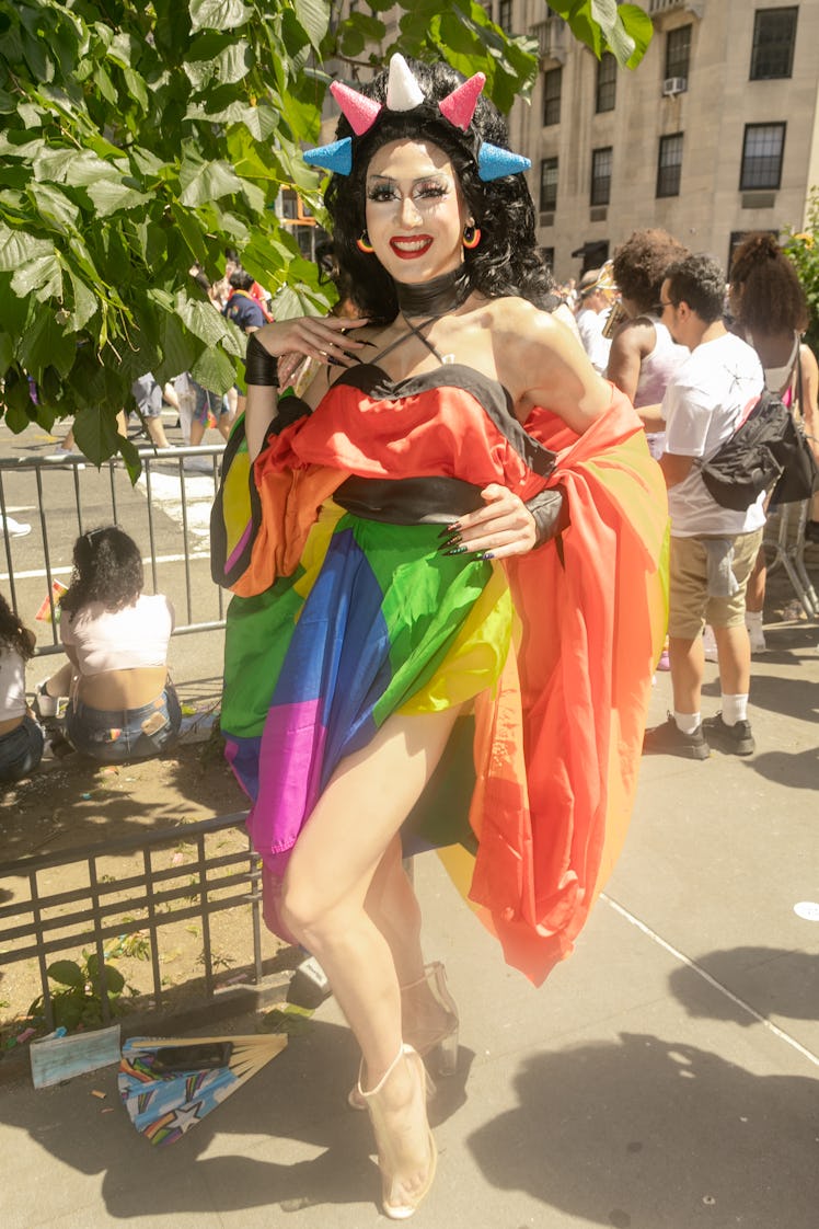 A person wearing a rainbow flag at the 2022 NYC Pride March