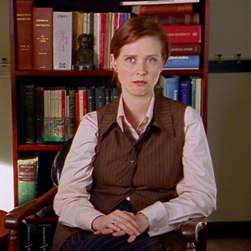 Miranda Hobbes wearing a brown pinstripe vest over a light pink shirt.
