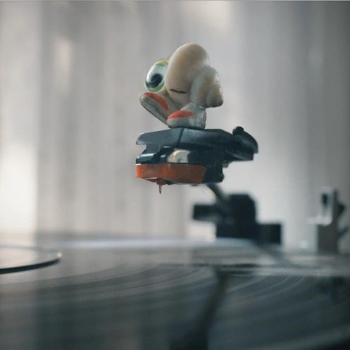 Marcel the Shell over a record player.