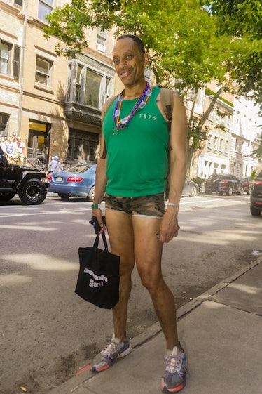A person wearing a green tank top at the 2022 NYC Pride March