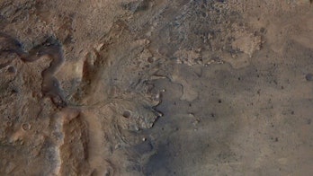 Satellite view of a fan-shaped deposit of sediment on a Martian plain.