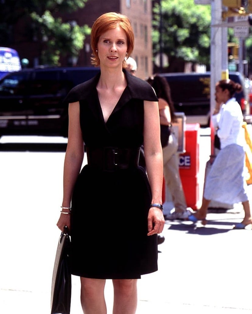 Miranda Hobbes in a belted black dress.