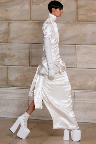 Model on the NY Fashion Week Fall 2022 runway in a Marc Jacobs white dress and white heels