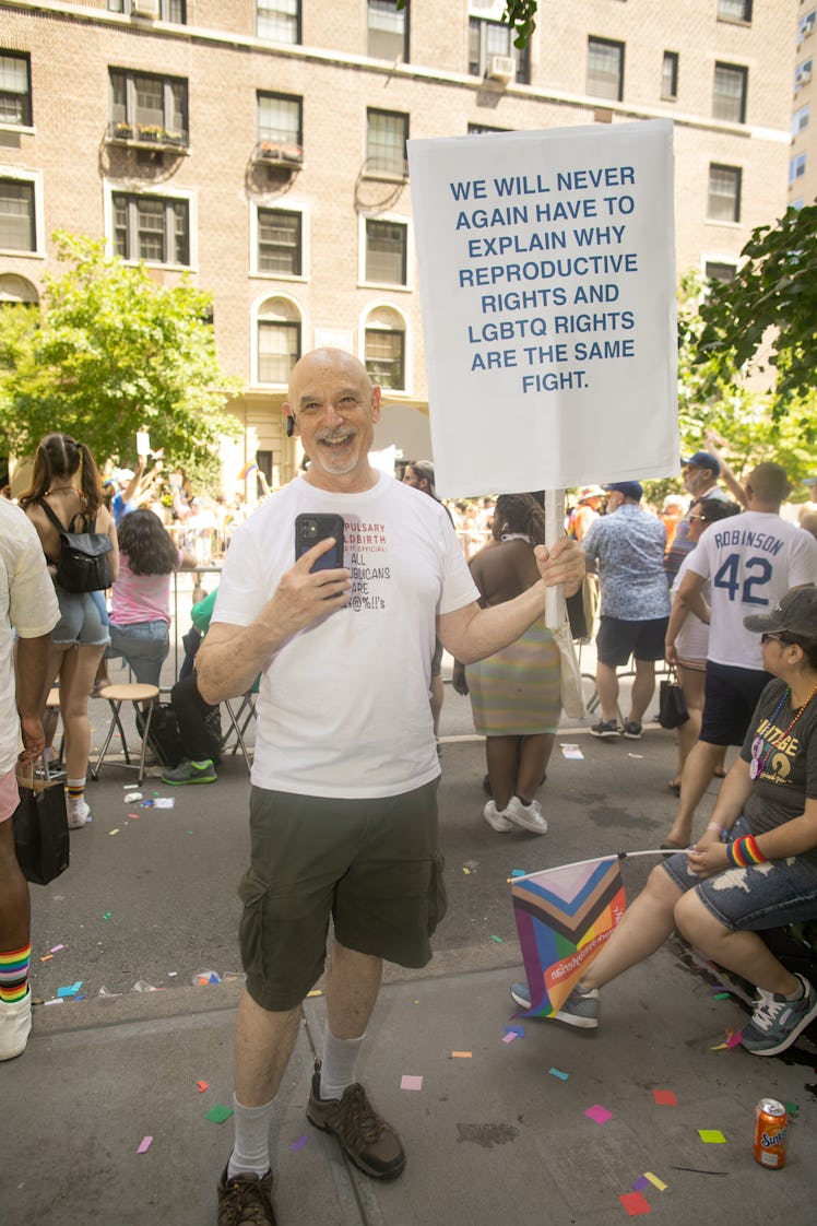 A person carrying a sign about reproductive and LGBTQ rights at the 2022 NYC Pride March
