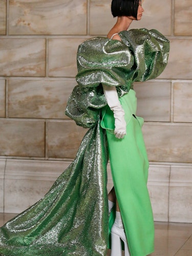 A model wearing a large green Marc Jacobs dress