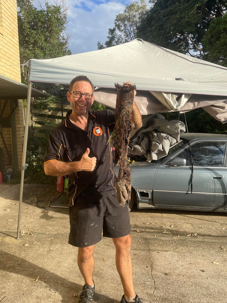 Drain unblocker Gavin Doran holding tree roots