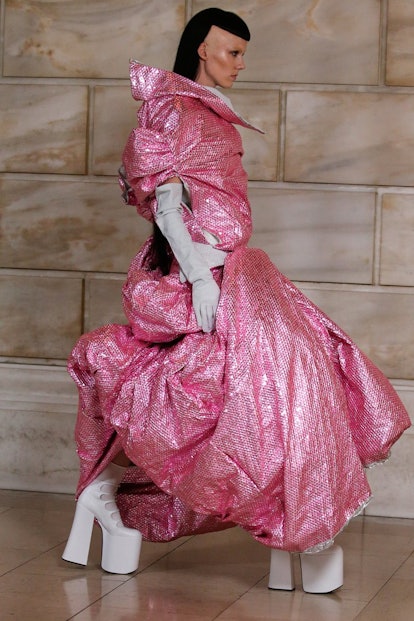 Model on the NY Fashion Week Fall 2022 runway in a Marc Jacobs oversized pink glossy dress and white...