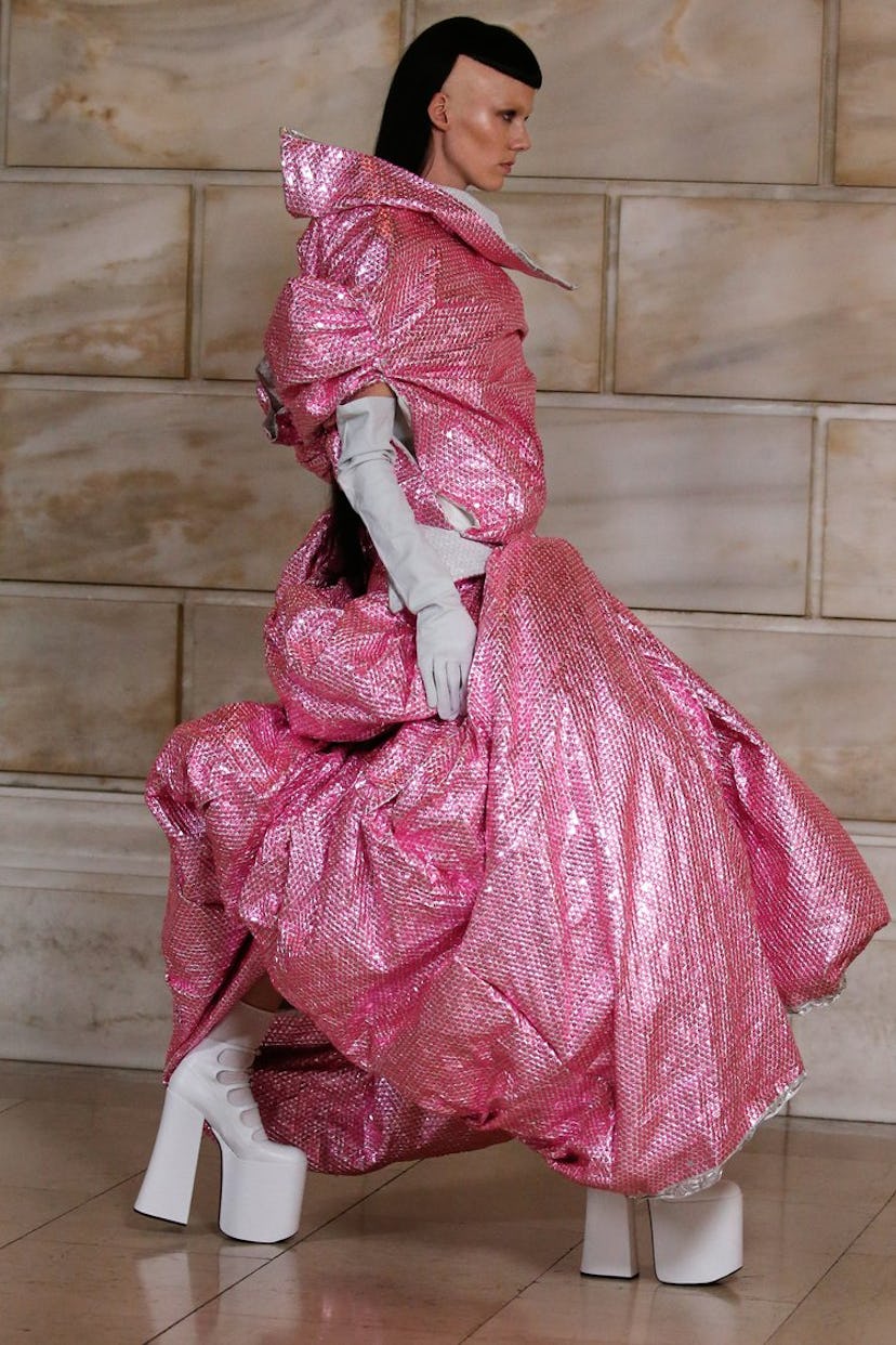 Model on the NY Fashion Week Fall 2022 runway in a Marc Jacobs oversized pink glossy dress and white...