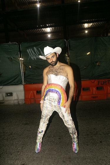 A person wearing a white cowboy hat and rainbow at Ladyfag's 2022 Pride party