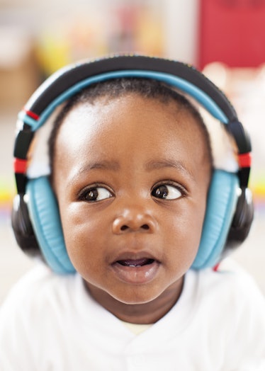 A baby wearing headphones to block out the sound of fireworks.