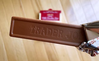 Slim chocolate bar half unwrapped.